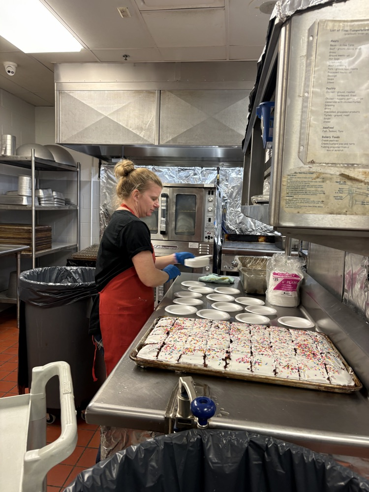 picture of teacher cutting cake 