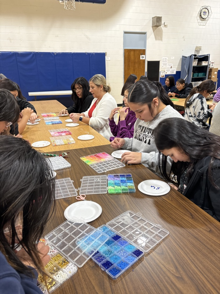 students making bracelets with beads 