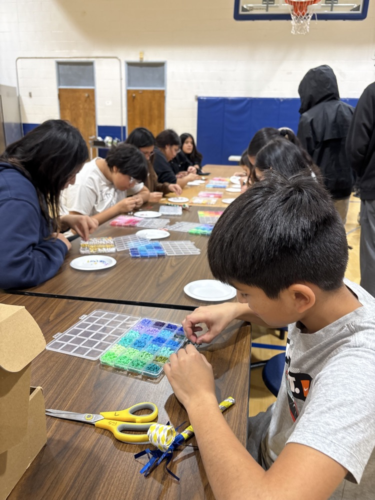 students making bracelets with beads 