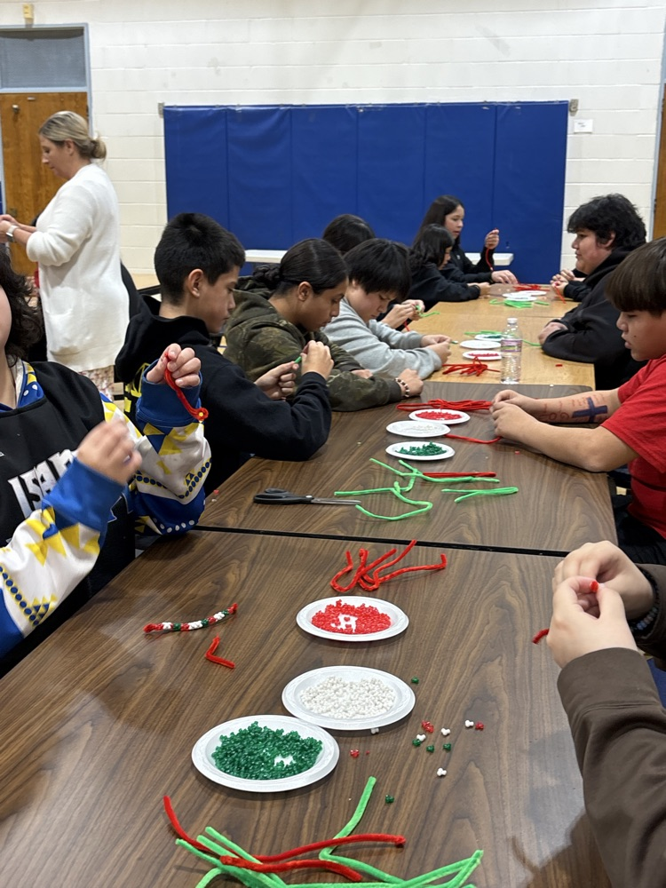 students making tree ornaments with beads 
