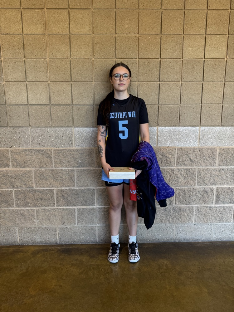 picture of basketball player #5 holding her all tourney award