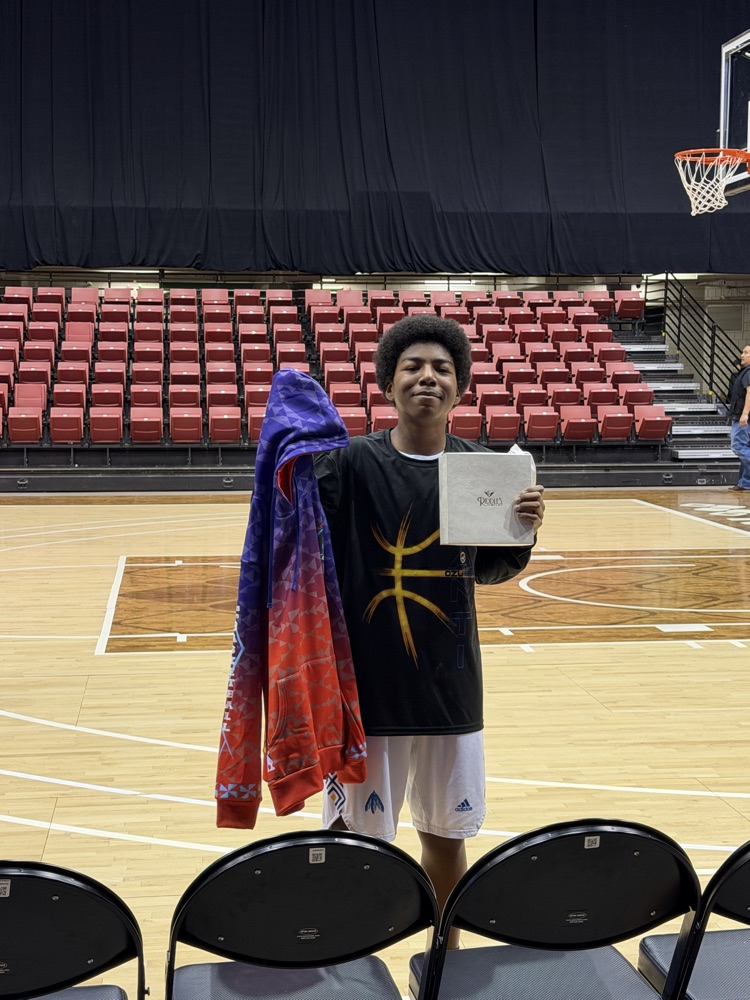 picture of basketball player #5 holding his all tourney award