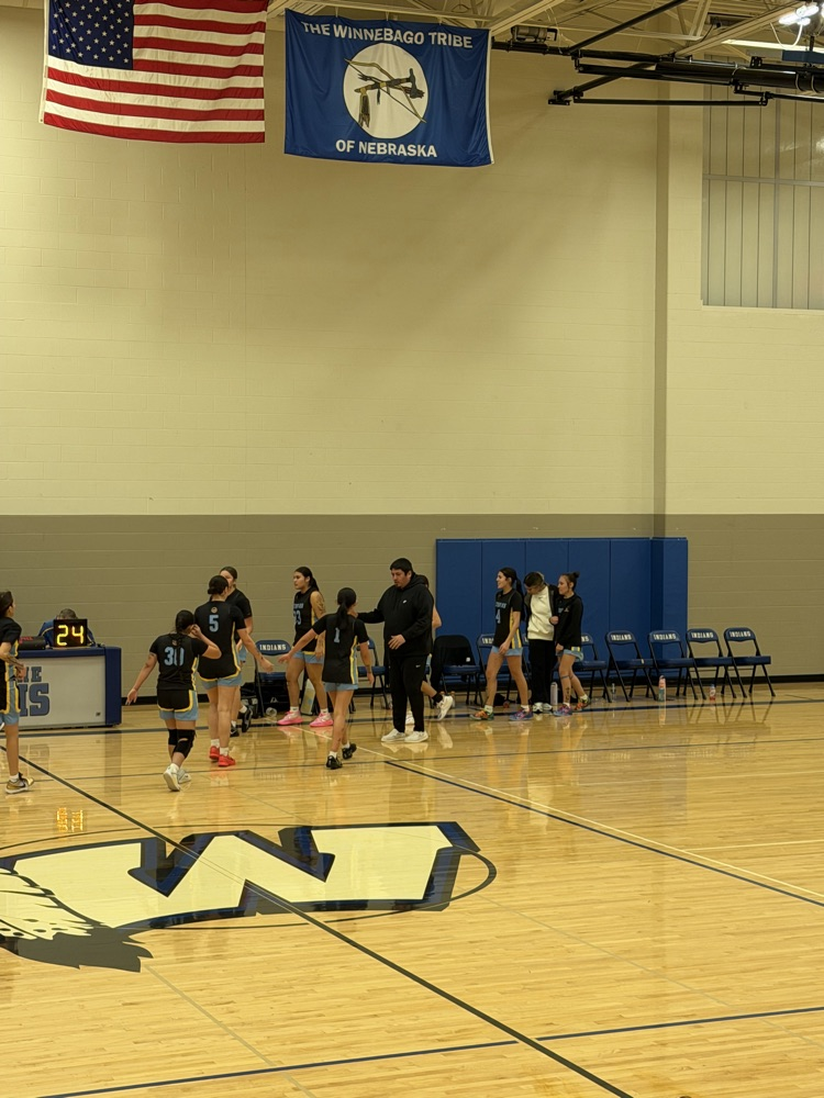 photo of our varsity girls team forming a line after their game win 