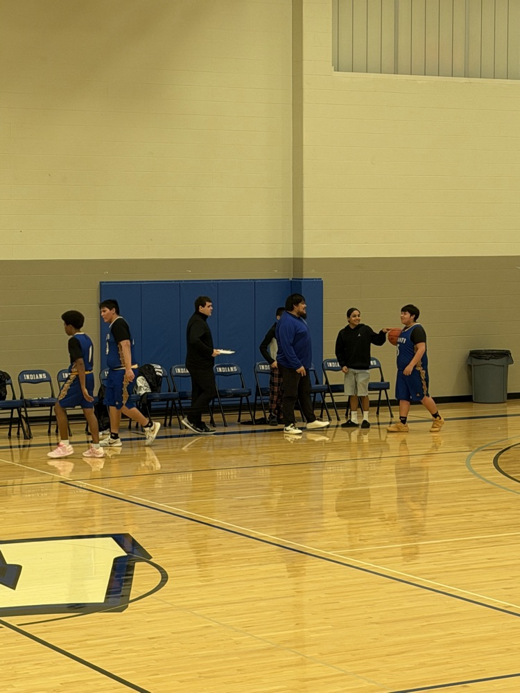 photo of warrior boys basketball team shaking hands with the opposing team 