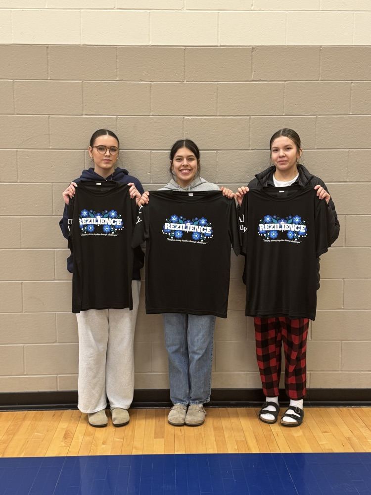 picture of 3 students holding up their black all tournament shirts 