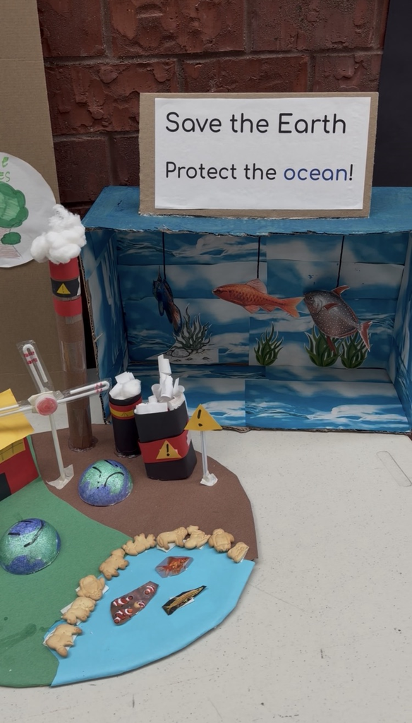 art project of the earth with windmills and recyclables 