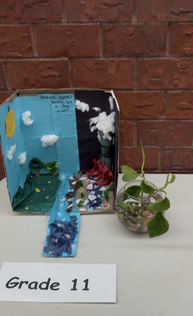art project- earth made out of a box with a river and trees 