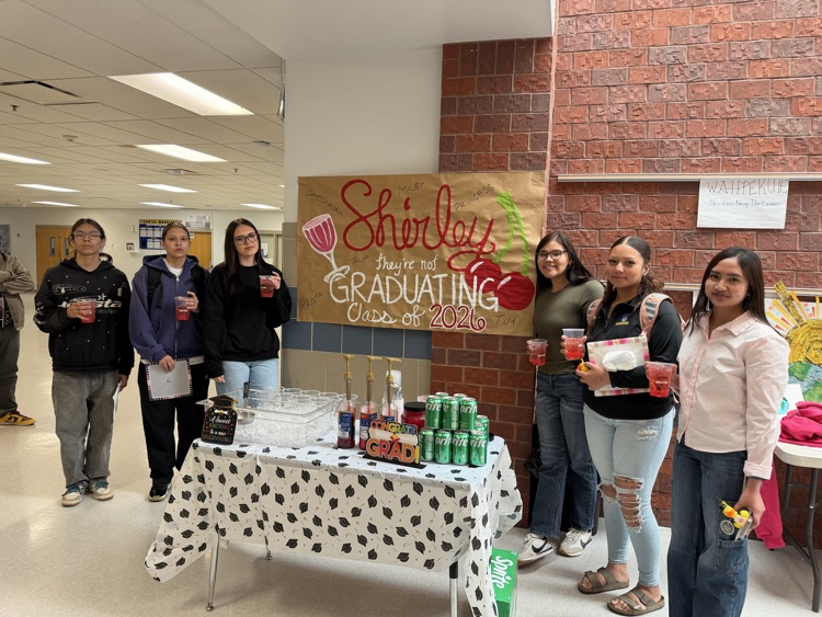 Image of five females and one male standing in front of a sign that says surely they are not graduating class of 2026