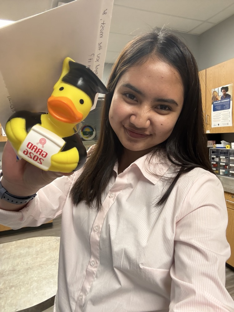 Image of a female in a white shirt holding a rubber duck