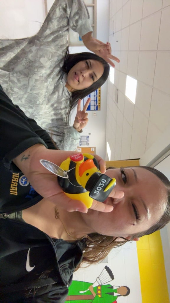 Image of a female and a black shirt holding a rubber duck
