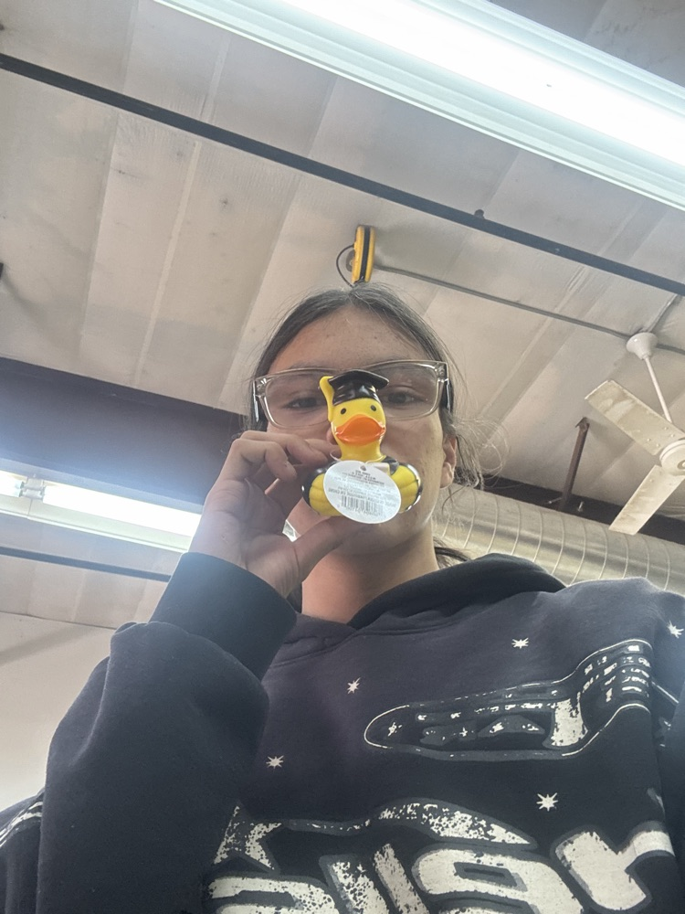 Image of a male and a black shirt holding a rubber duck