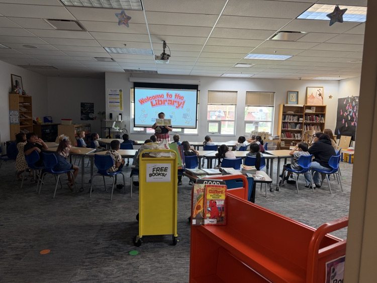 photo of students sitting at desks in the library. 