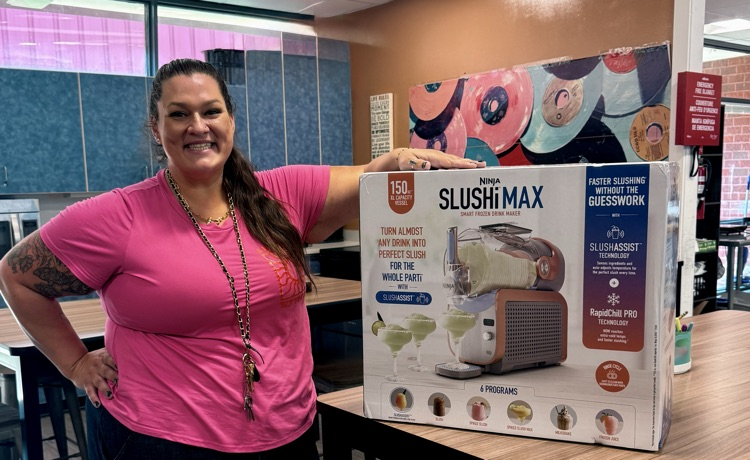 Teacher smiling beside a new Ninja SLUSHi Max in the Family and Consumer Sciences classroom.