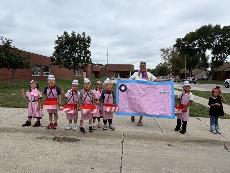 photo of small students in diner costumes getting ready for the parade 