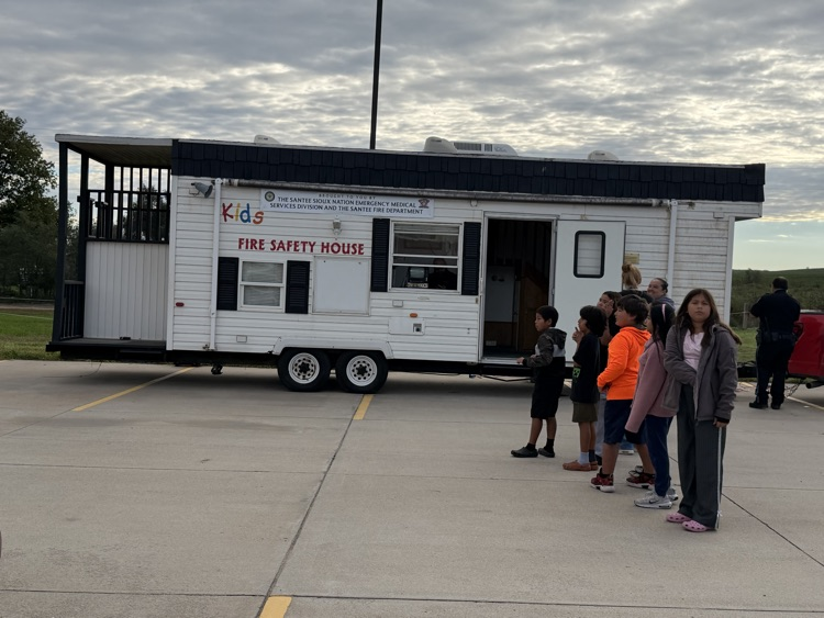 photo of a long white trailer that has been built as a smokehouse to help students practice fire safety 