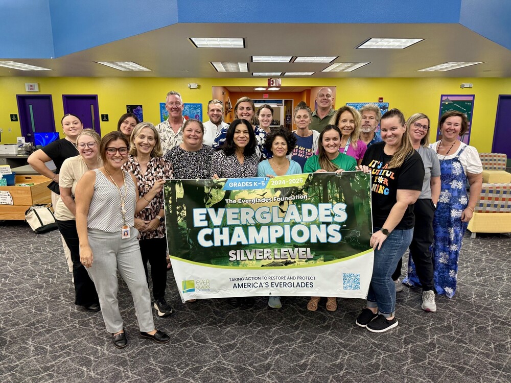 SCS Everglades Champions Silver Lever group photo holding a banner that says the title