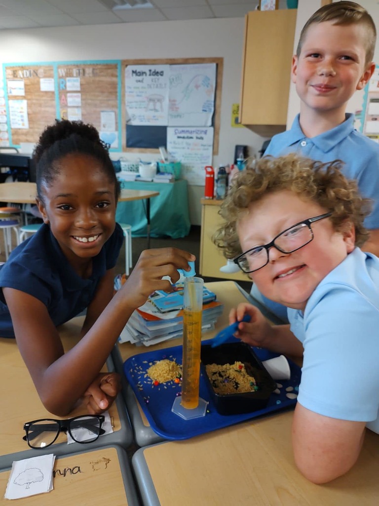 Kids in class learning about animal adaptations with a bird beak