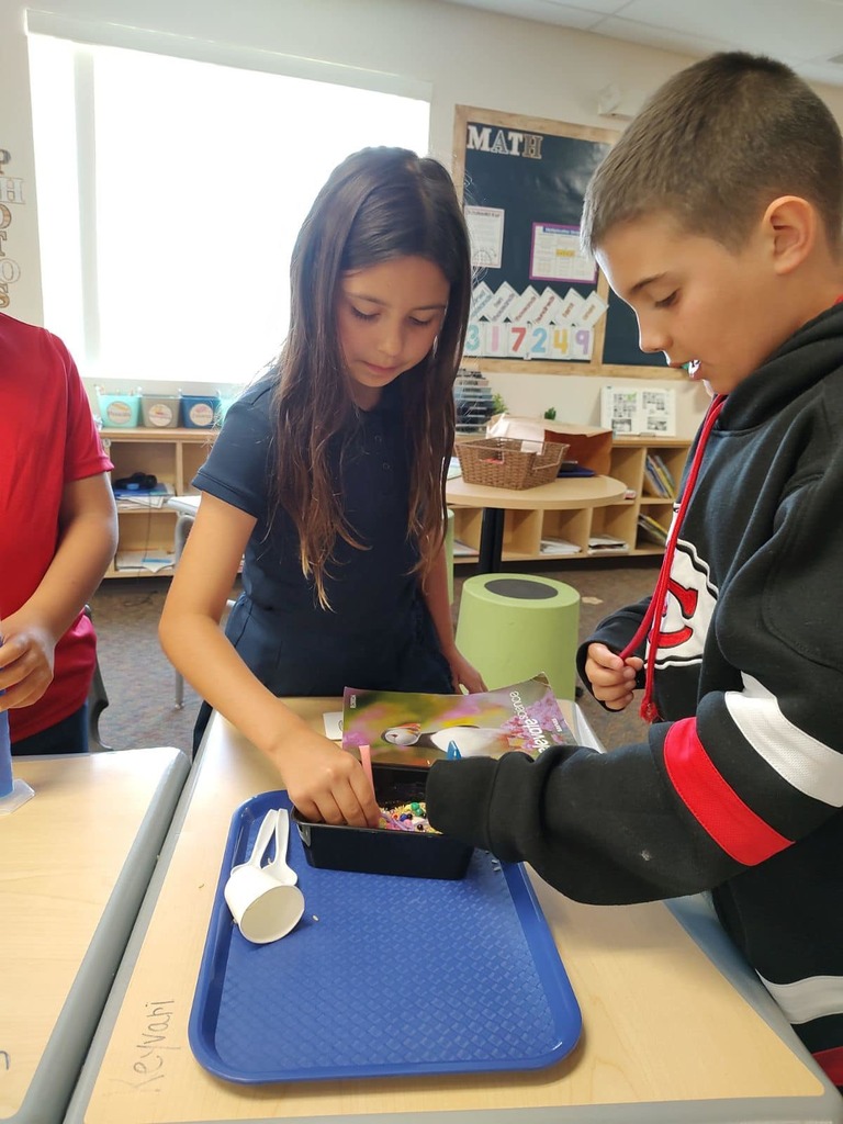 Kids in class learning about animal adaptations with a bird beak