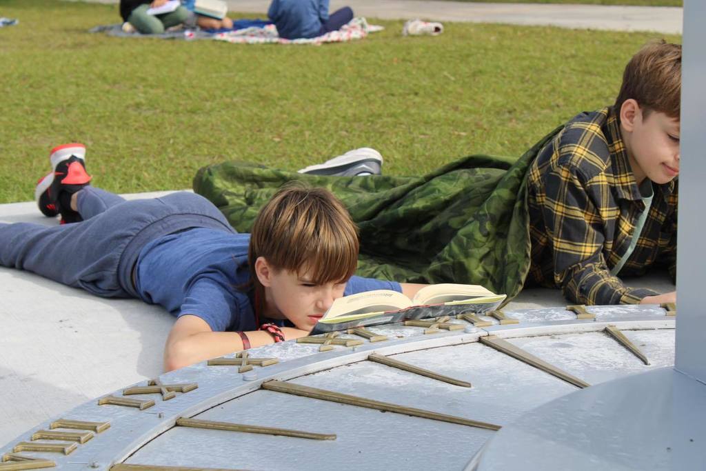 Student reading on the grass