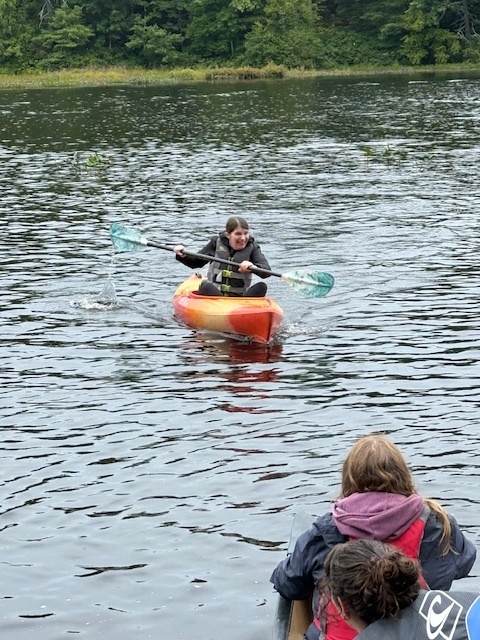 Mrs. Hewlett kayaking back to her team.