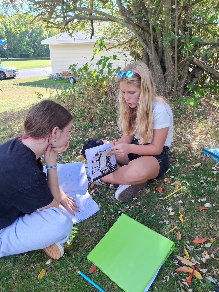 Students writing in the pollinator garden.