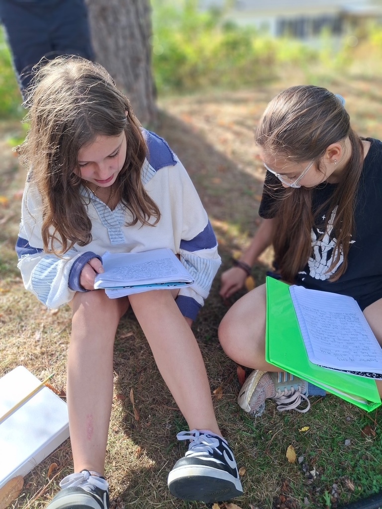 Students writing in the pollinator garden.