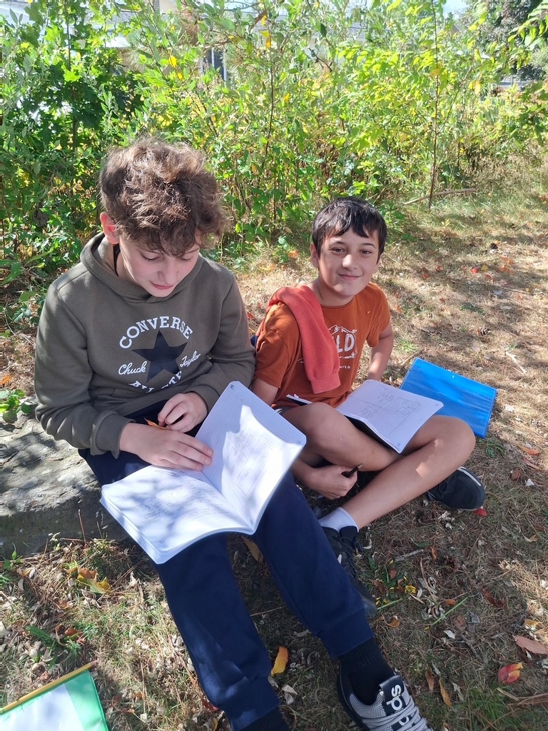 Students writing in the pollinator garden.