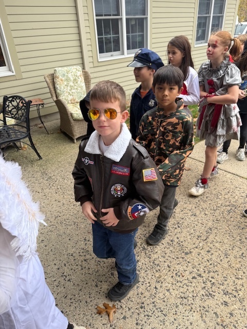 Students in costume, including one in a Top Gun costume, parading into Poplin.