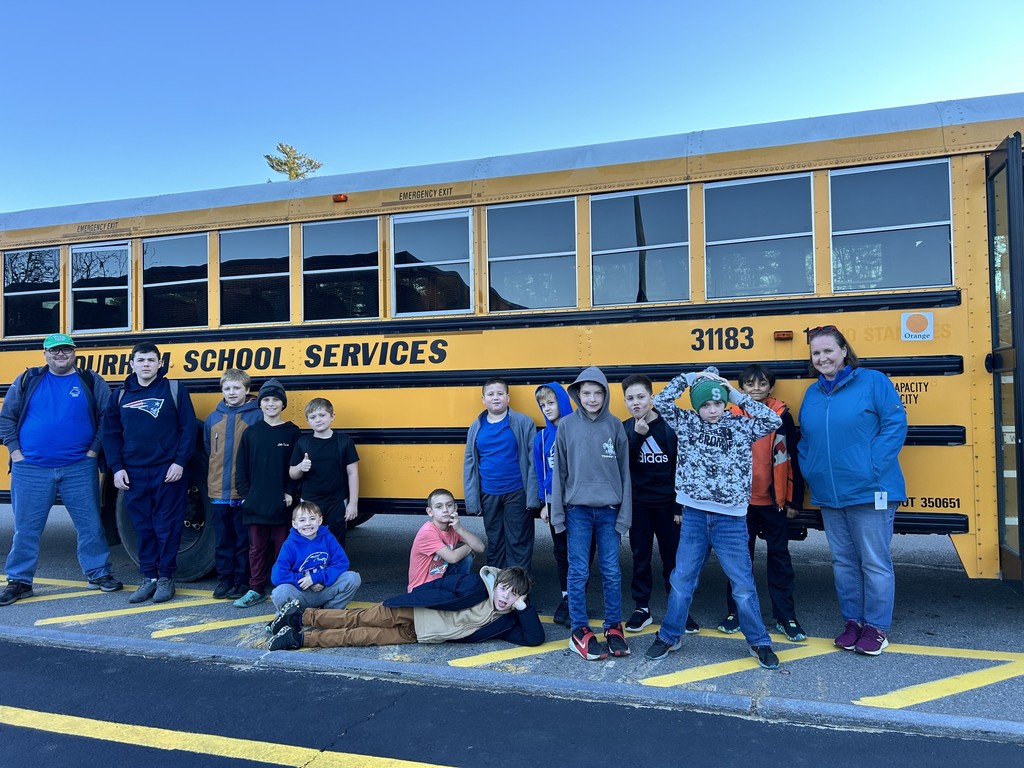 Robotics Team posing in front of the bus!
