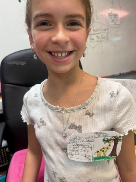 One of our fifth graders posing with her nametag