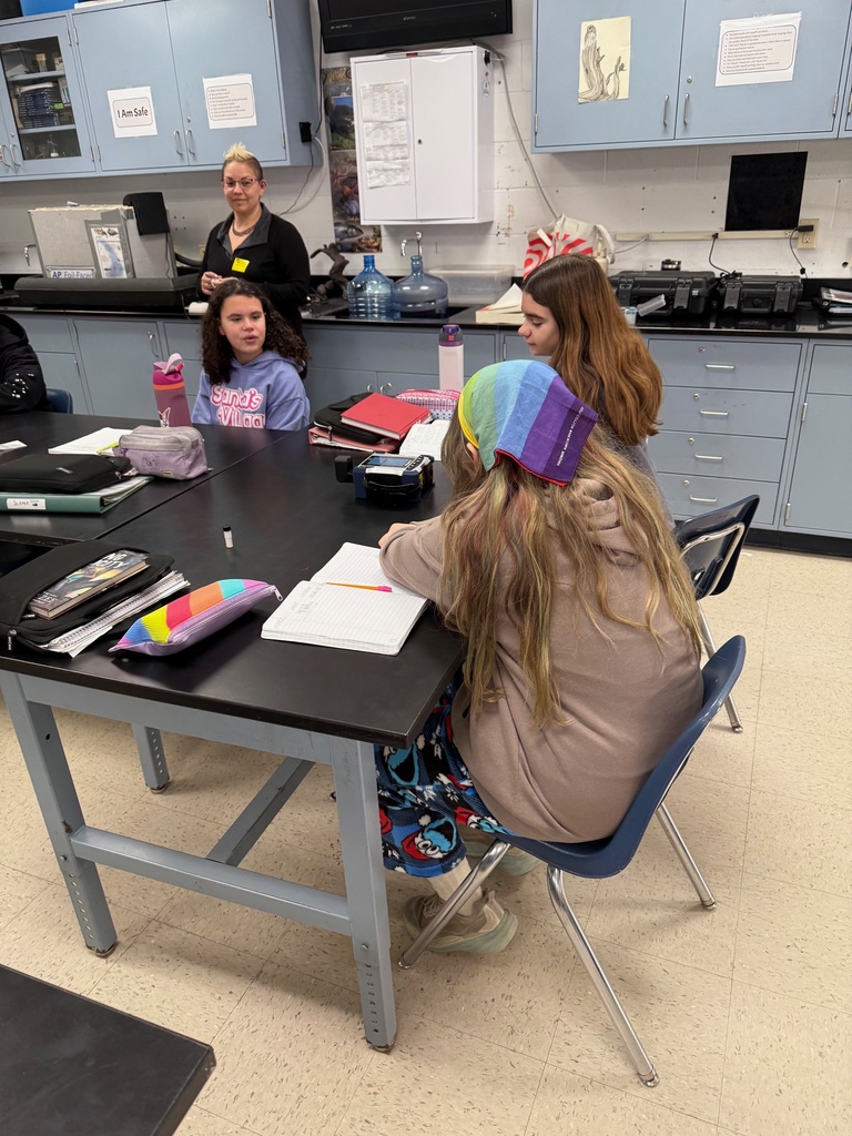 Dr. Profeta helping eighth graders use the device.