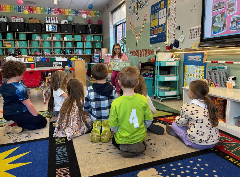 One of our older students reading to kindergarteners