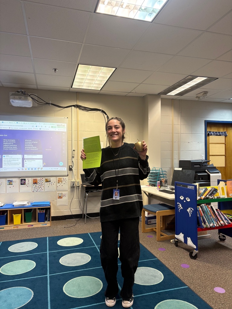 Mrs. MacArthur posing with the Golden Apple!