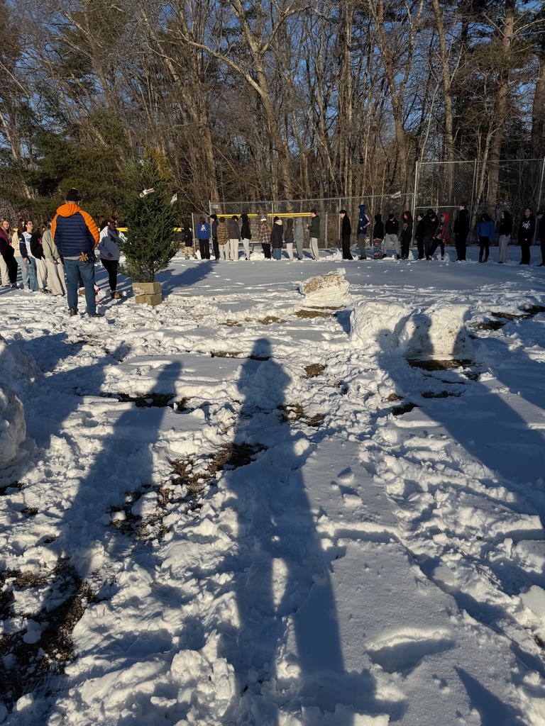 Students lining up to place their "grumps" in the structure