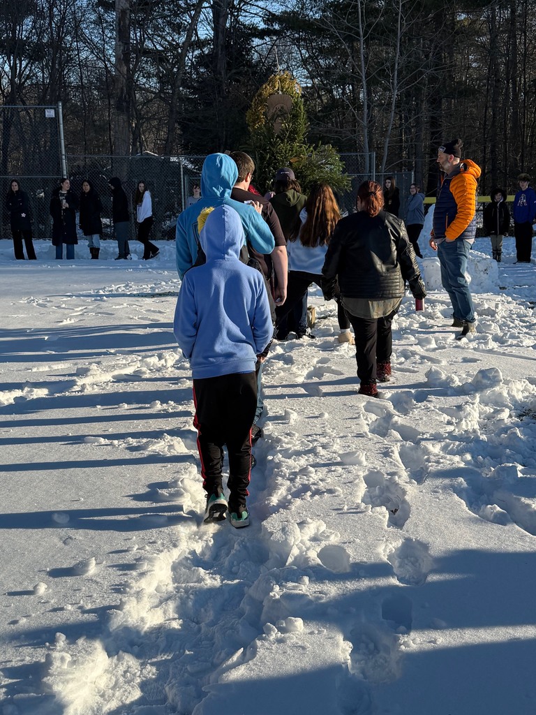 Students lining up to place their "grumps" in the structure