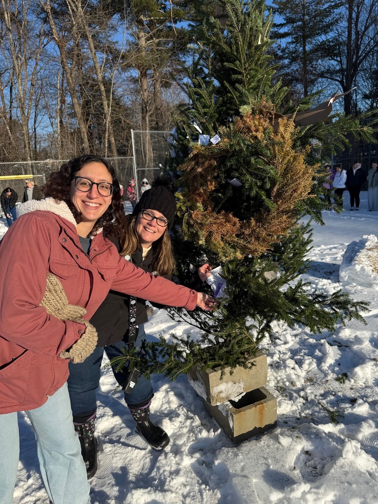 Mrs. Rosenberg and Ms. Bancroft placing their "grumps" in the structure.