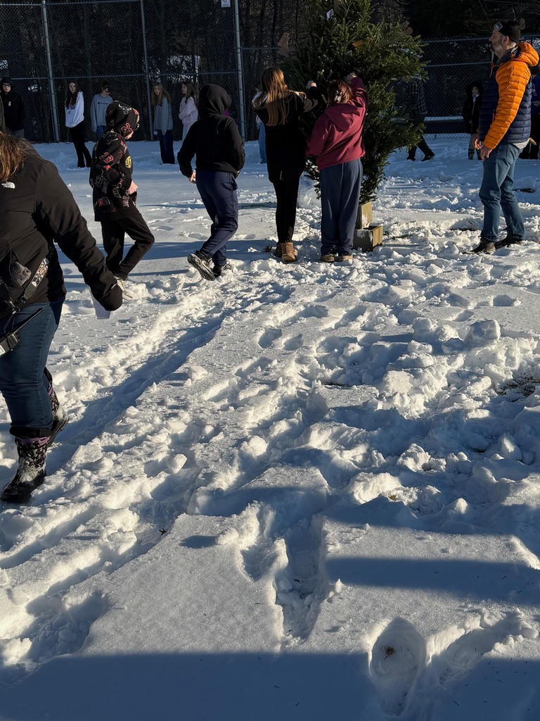 Students lining up to place their "grumps" in the structure