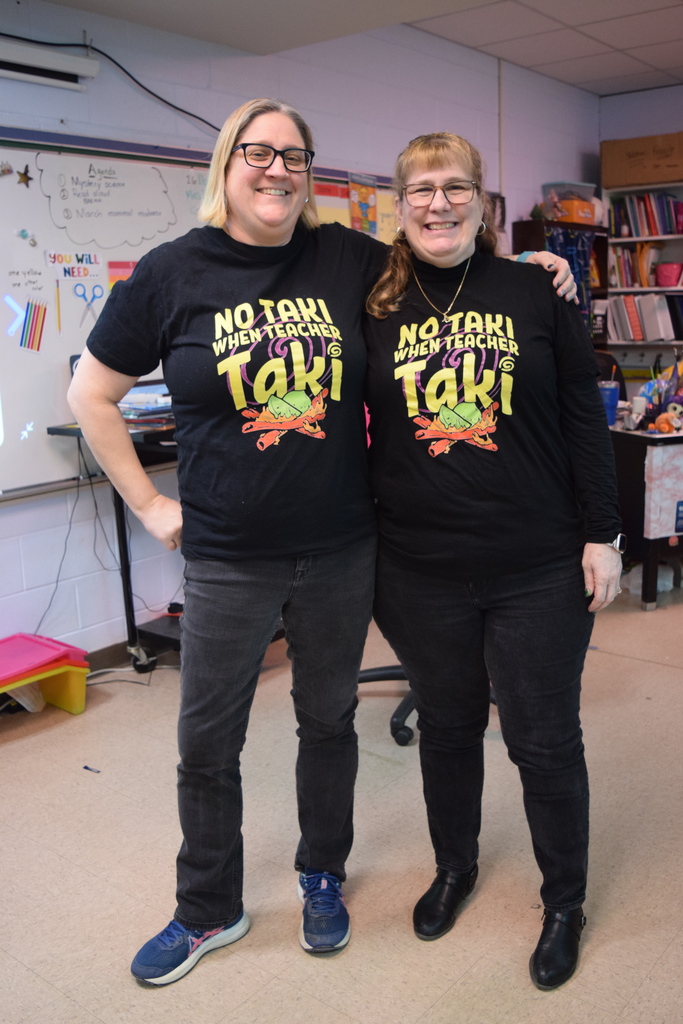 Two teachers twinning with "No Tki while teacher Taki" shirts
