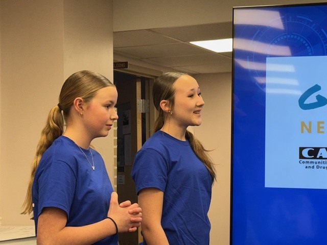 Students smiling at the beginning of their presentation