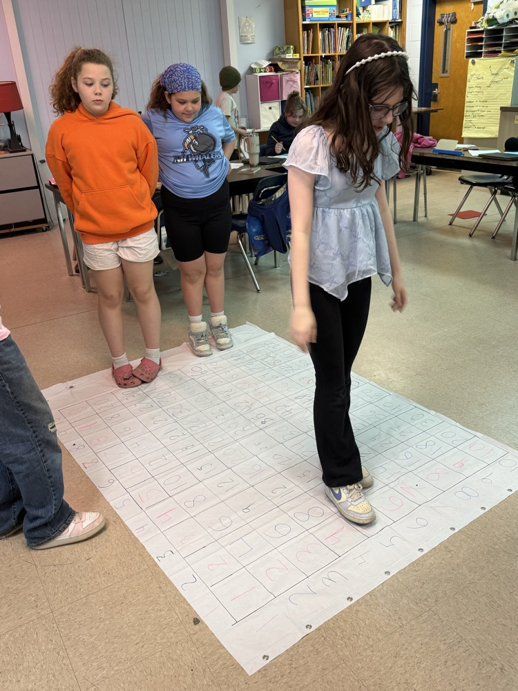 Students showcasing what they learned about simplifying fractions.