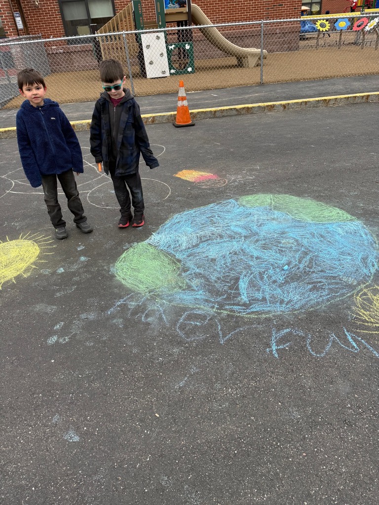 Students writing positive messages with chalk