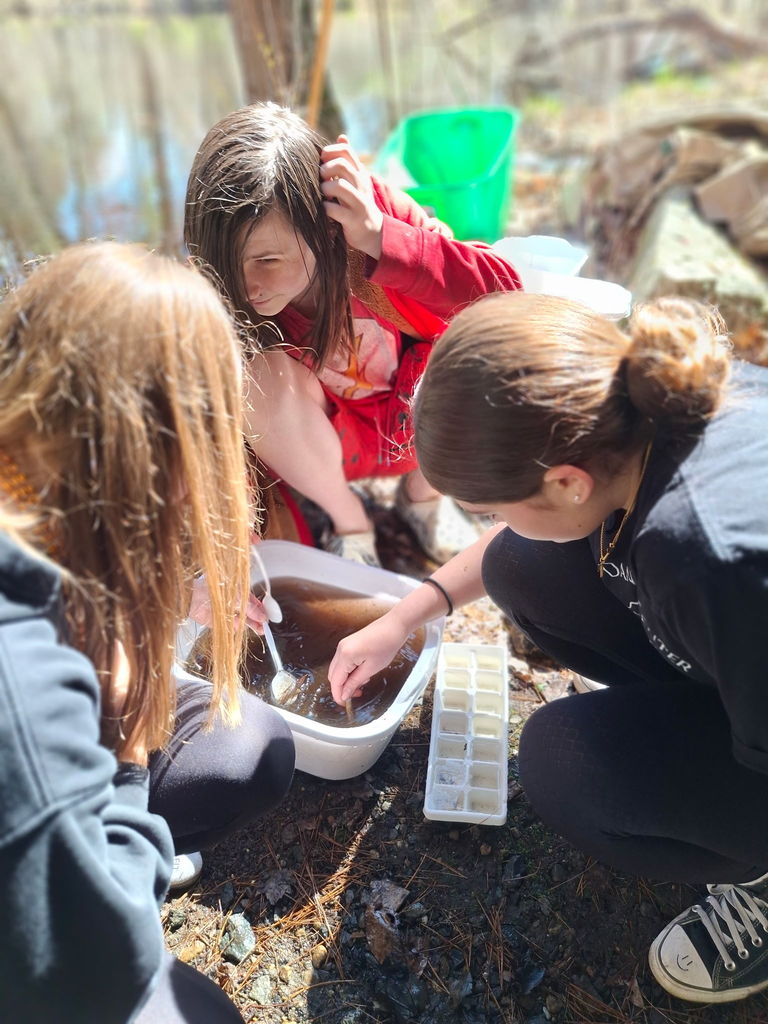 Three students testing the river water