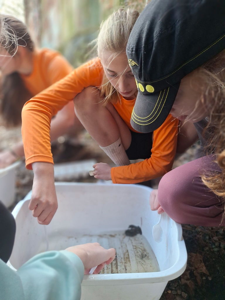 Three students testing the river water
