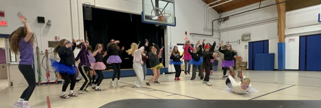A group of students dancing while one is doing the worm