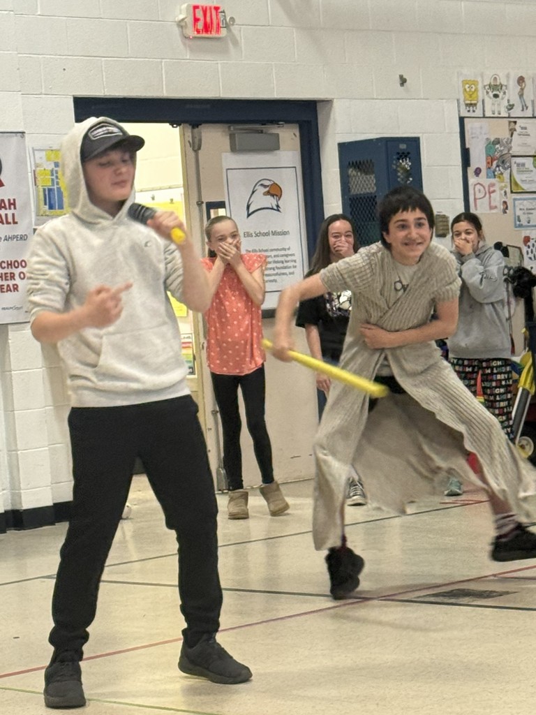 Two students lip syncing and one dancing with a bat