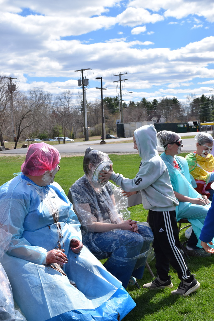 A student pieing a teacher in the face!