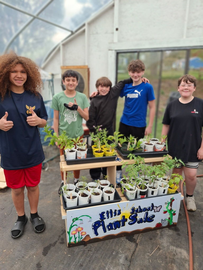 Students posing with their plant sale arrangement