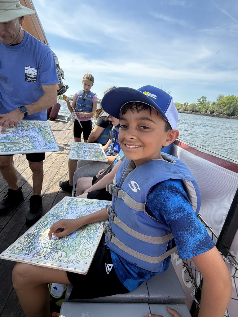 A student smiling as he reads the map.