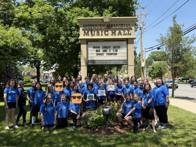 Students posing in front of Methuen Memorial Music Hall with their three medals