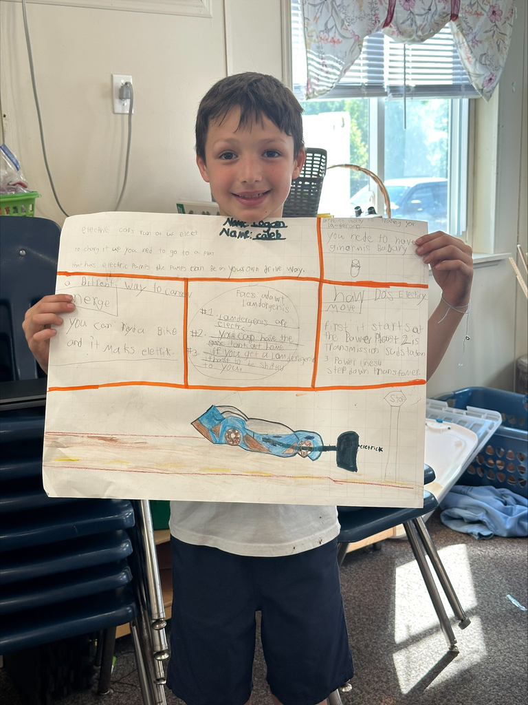 A student smiling with his energy project